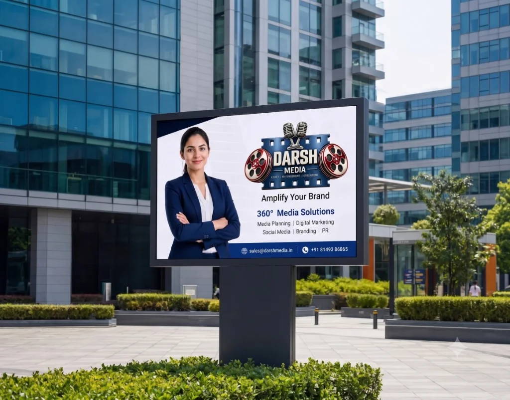 Realistic Darsh Media digital outdoor billboard design featuring dual retro film reels and microphone brand artwork, Amplify Your Brand tagline, and official contact phone and email