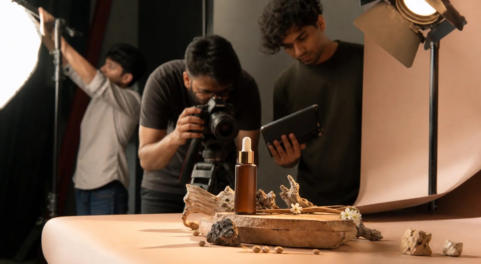 A commercial product video being filmed in a studio with dramatic lighting